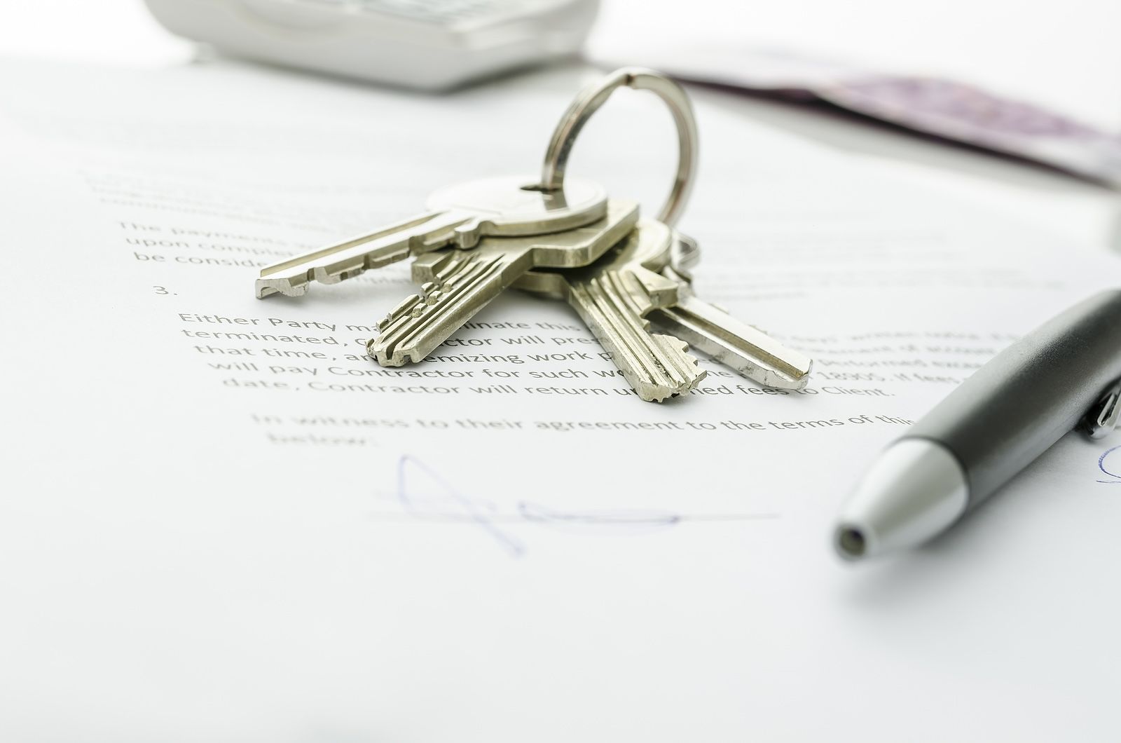 Keys and pen on paperwork representing a real estate closing