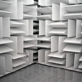 A room with a lot of white boxes on the wall