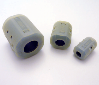 Three plastic cylinders with holes in them are sitting on a white surface