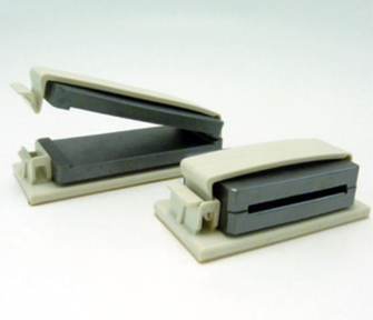 A pair of staplers are sitting on a white surface