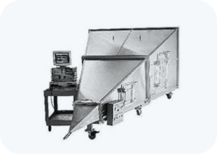 A black and white photo of a machine with a computer on top of it.