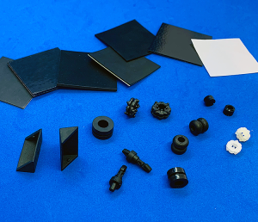 A bunch of black rubber pieces on a blue surface