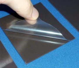 A person is peeling off a piece of plastic