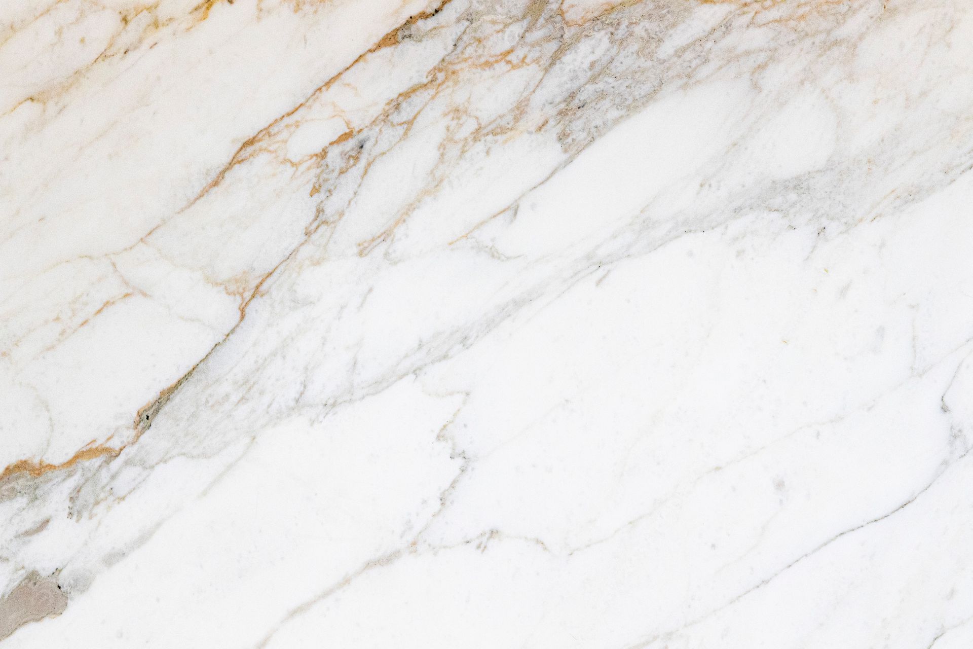 White marble with gold and gray veining.