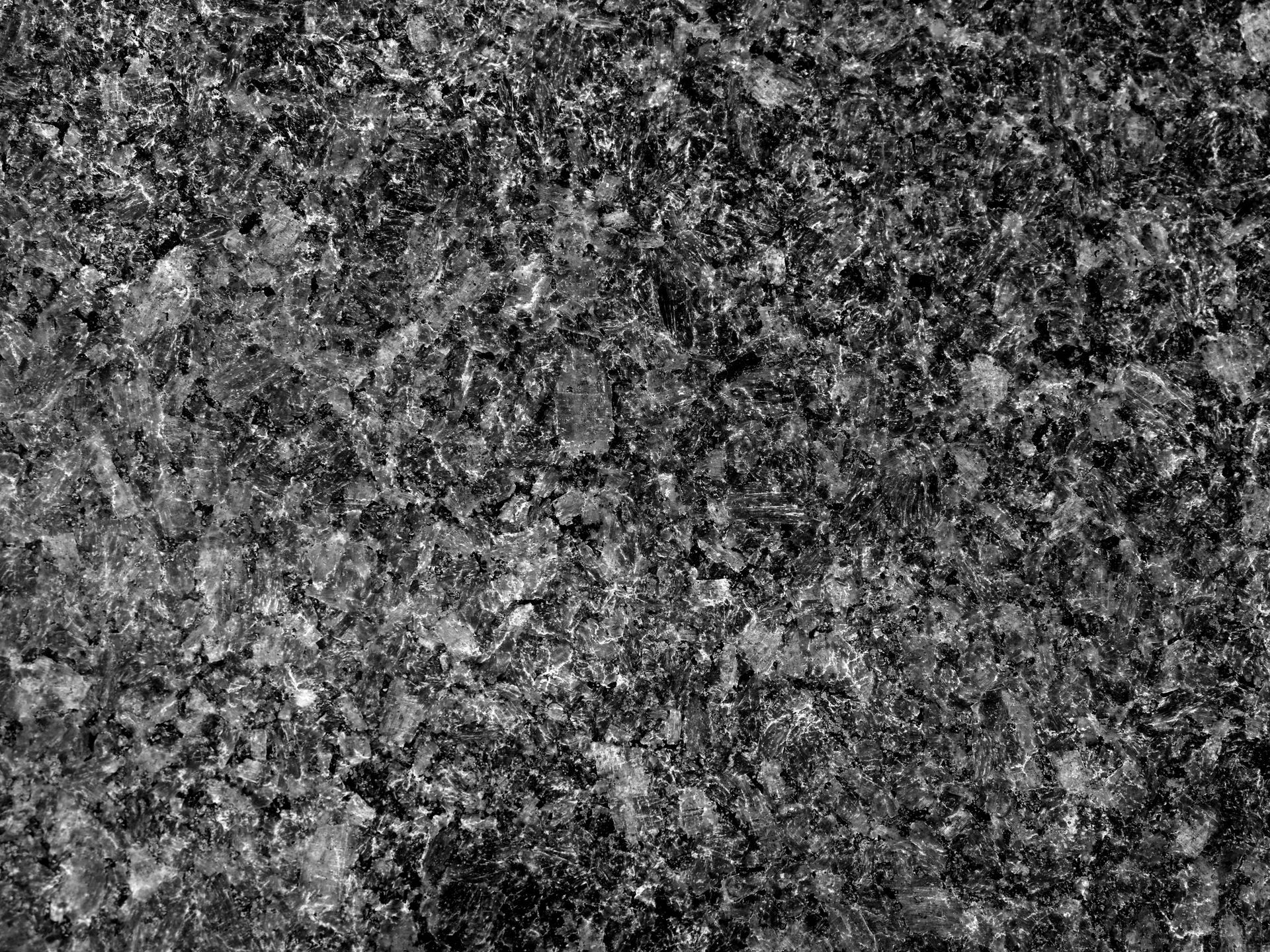 Black and white granite texture, rough and granular.