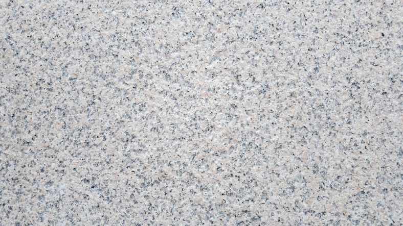 Gray and white speckled granite stone surface.