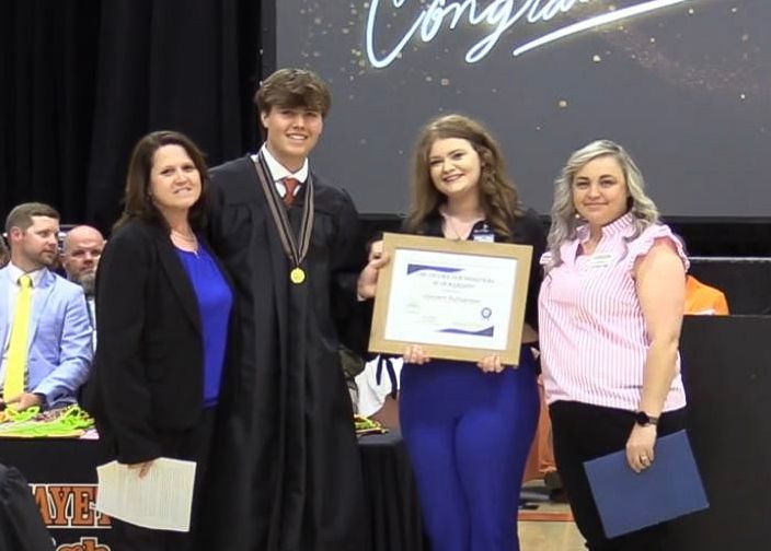 Mason Bridges Scholarship winner with Celina Team
