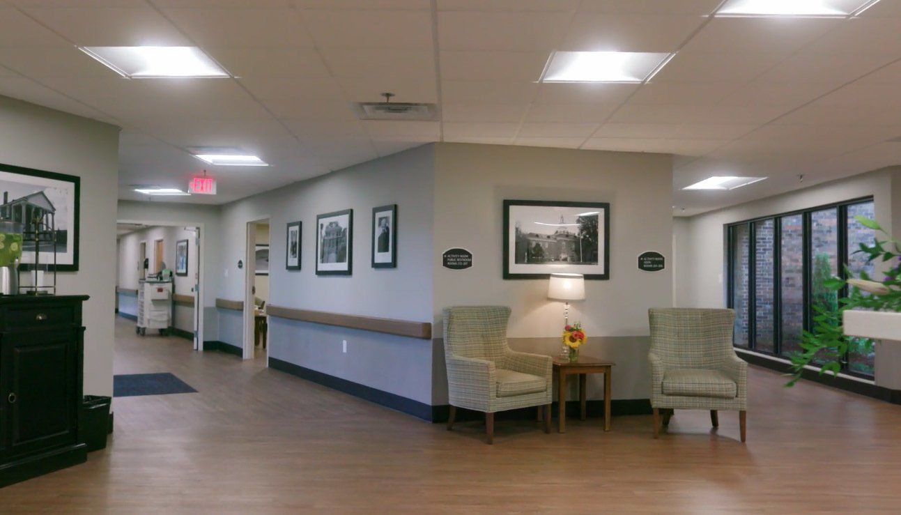 A hallway in a hospital with chairs and lamps