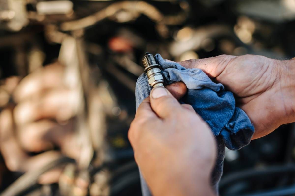 Transmission specialist near Cincinnati, OH, checking a spark plug near Cincinnati, Ohio