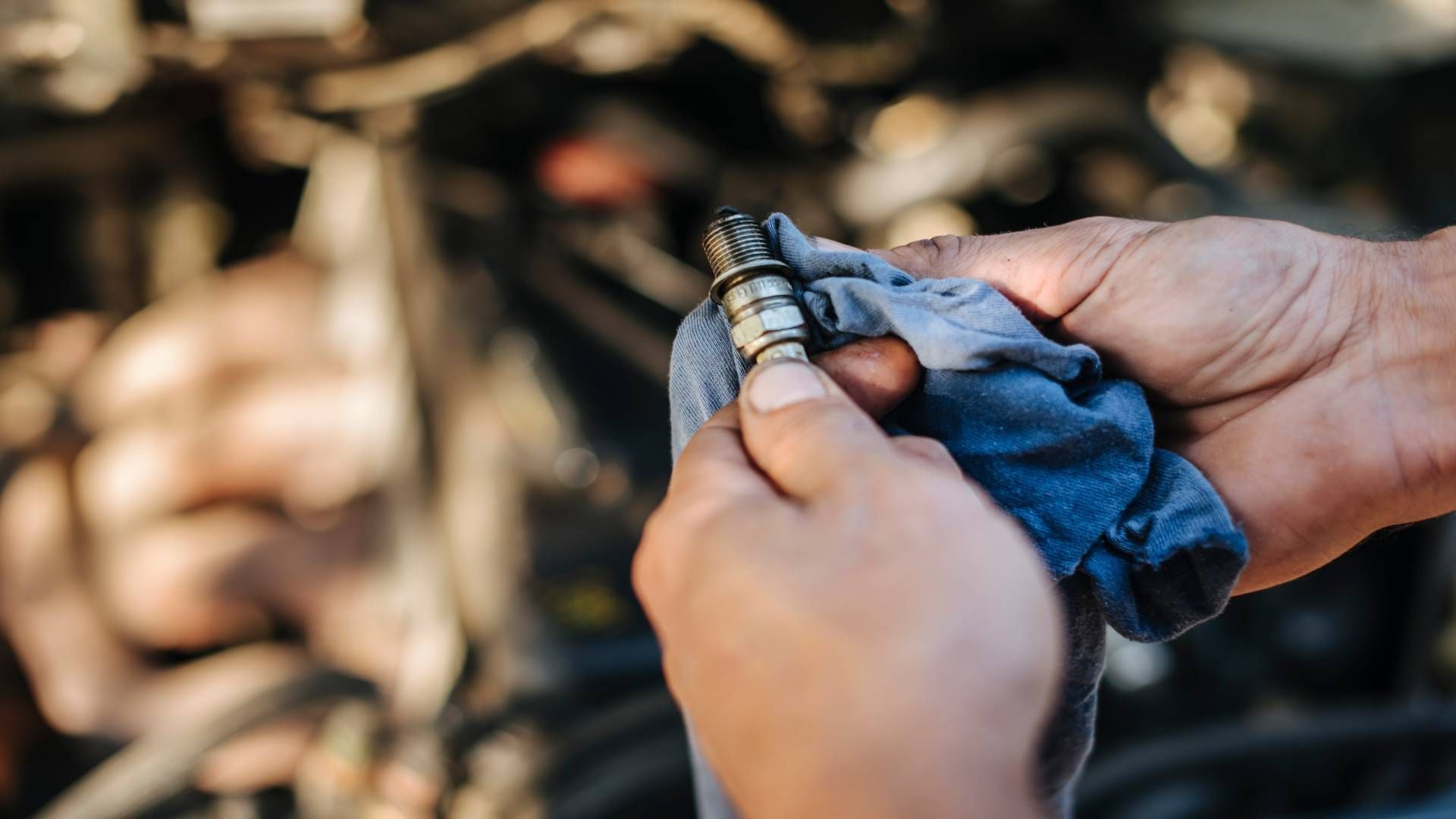 Transmission specialist near Cincinnati, OH, checking a spark plug near Cincinnati, Ohio