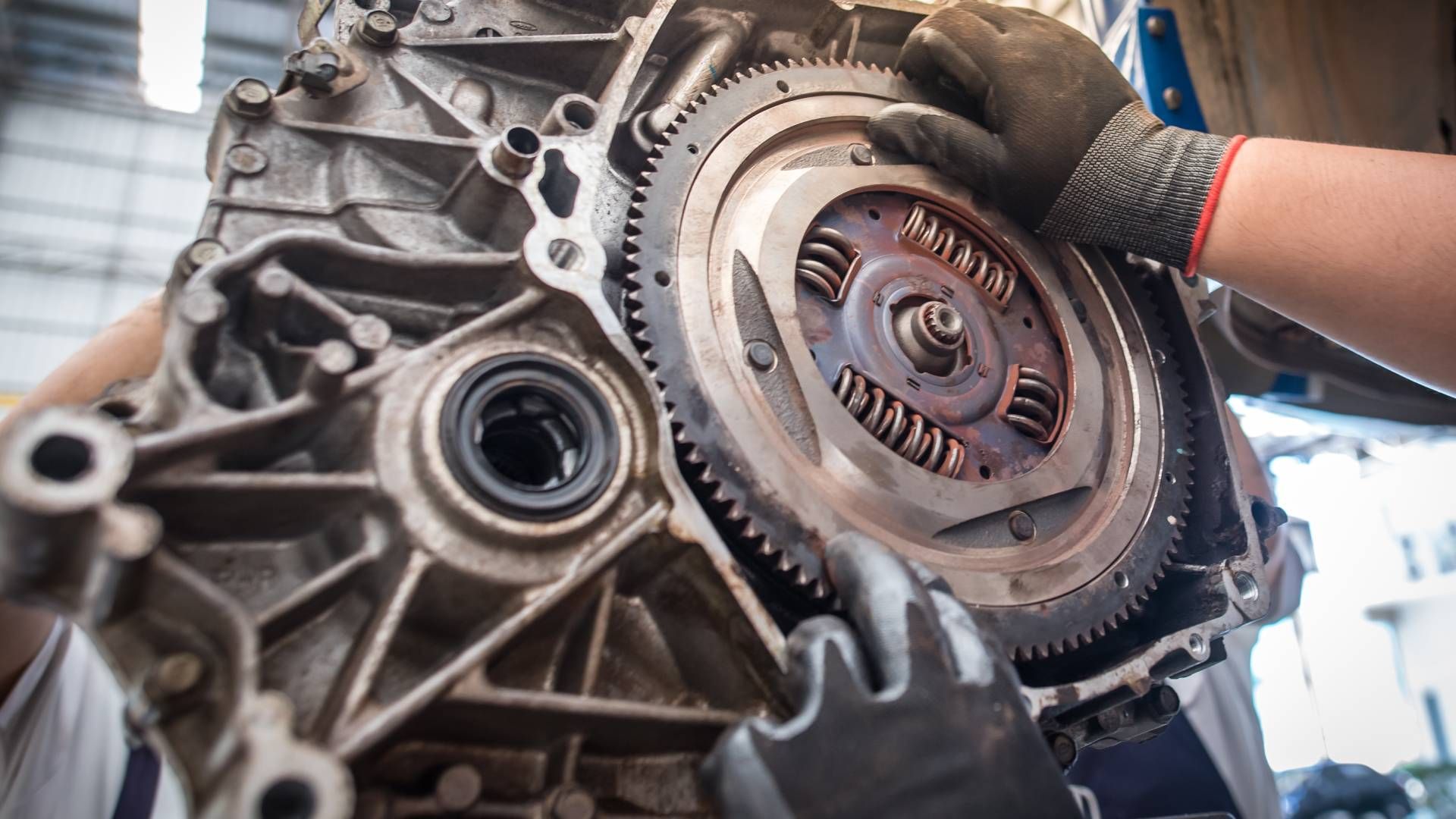 Two auto mechanics working on part of an engine at Mr. Transmission near Cincinnati, OH