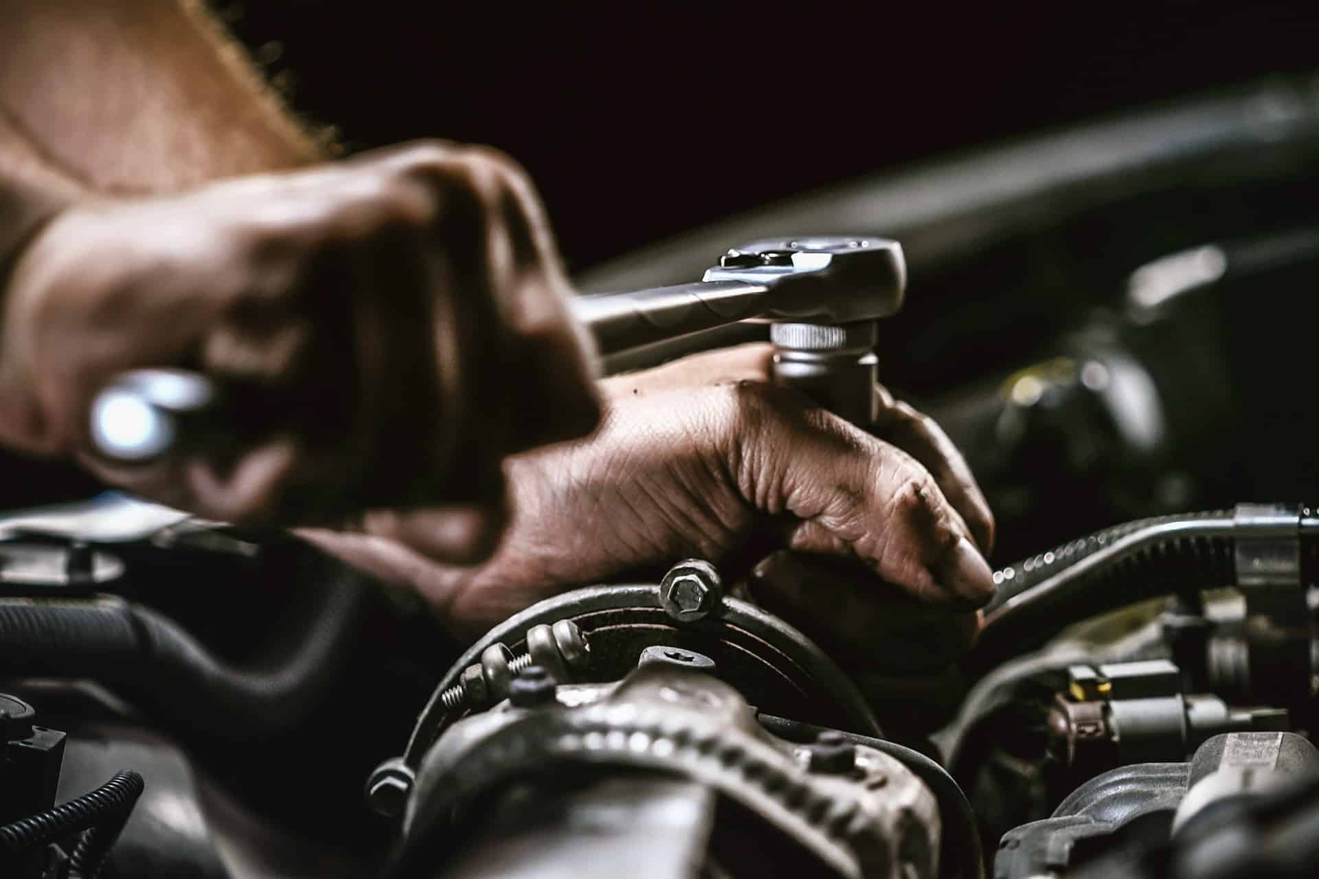 Mechanic repairing a transmission in a garage