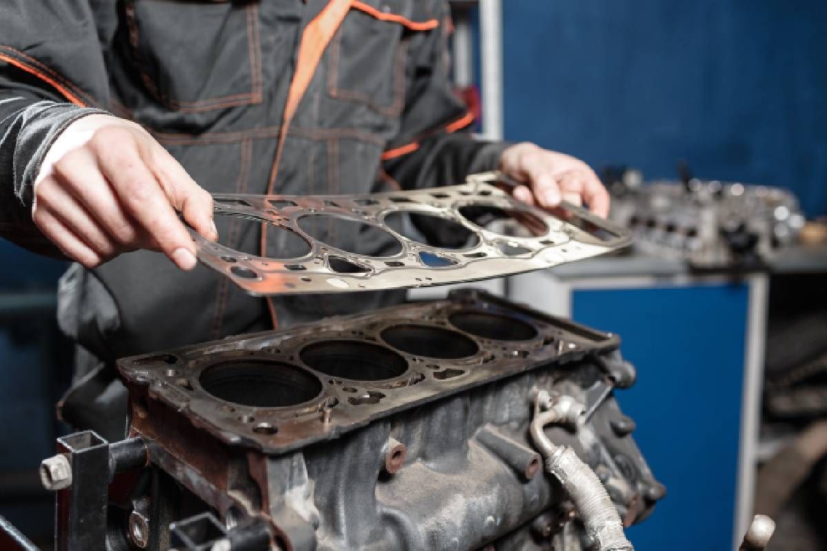 Mechanic installing a sealing gasket in a shop near Cincinnati, OH