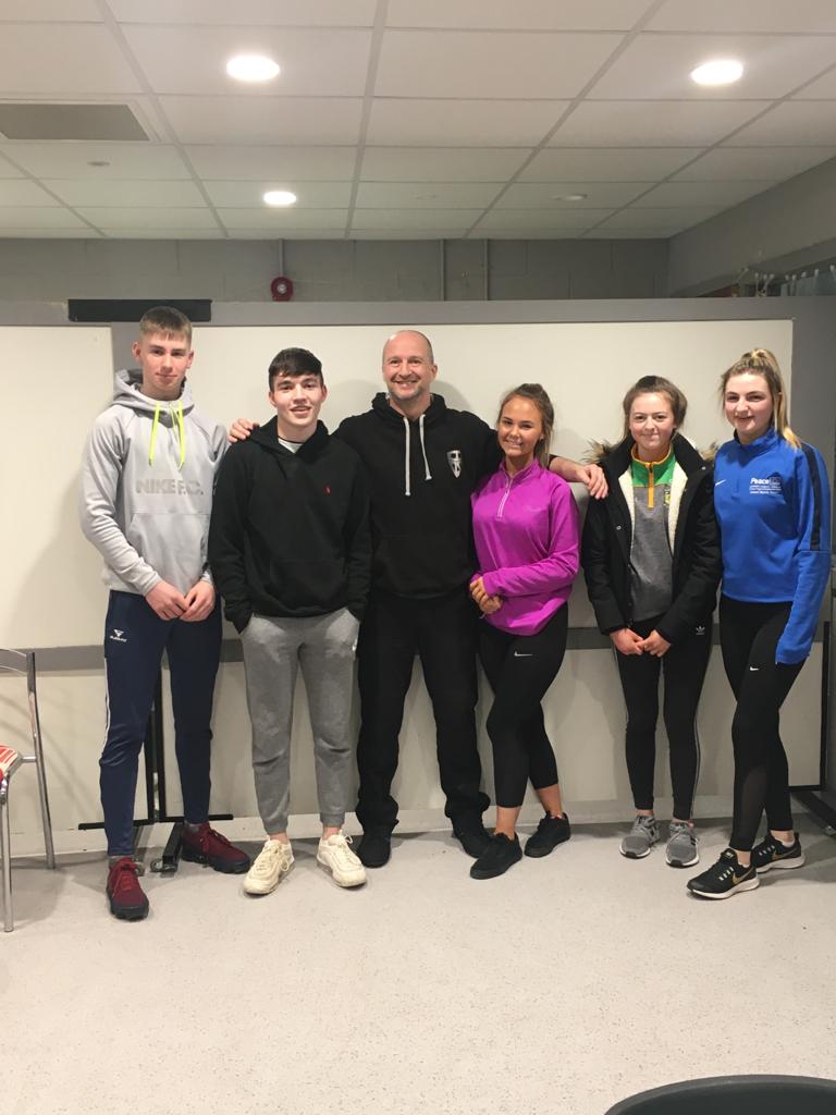Five students with instructor at the glow project venue self protection evening