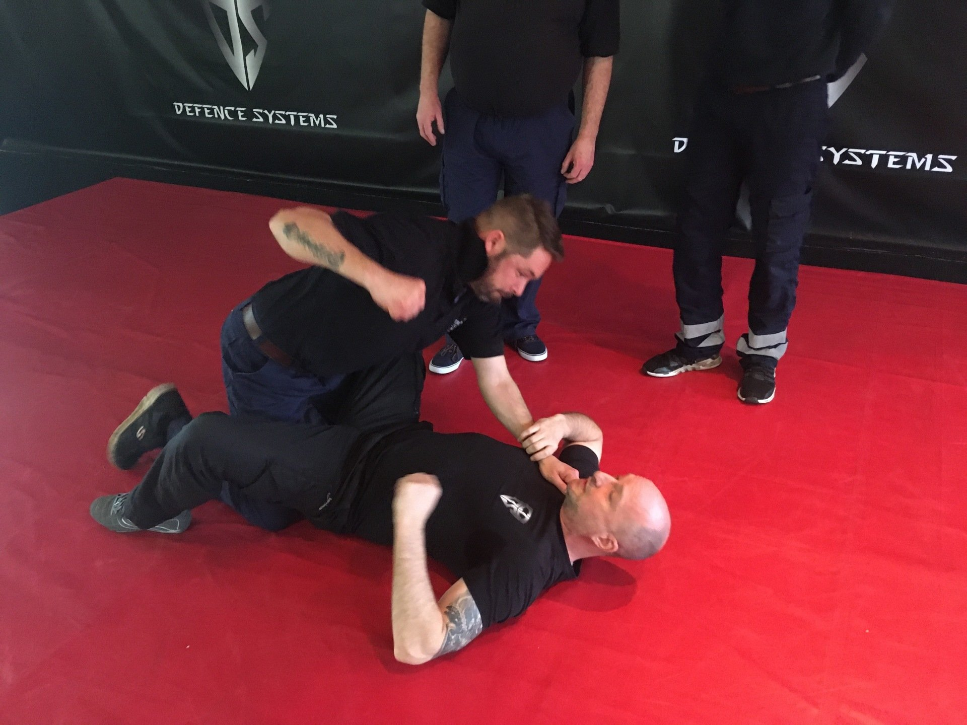 Self defence instruction technique against punching ground threat