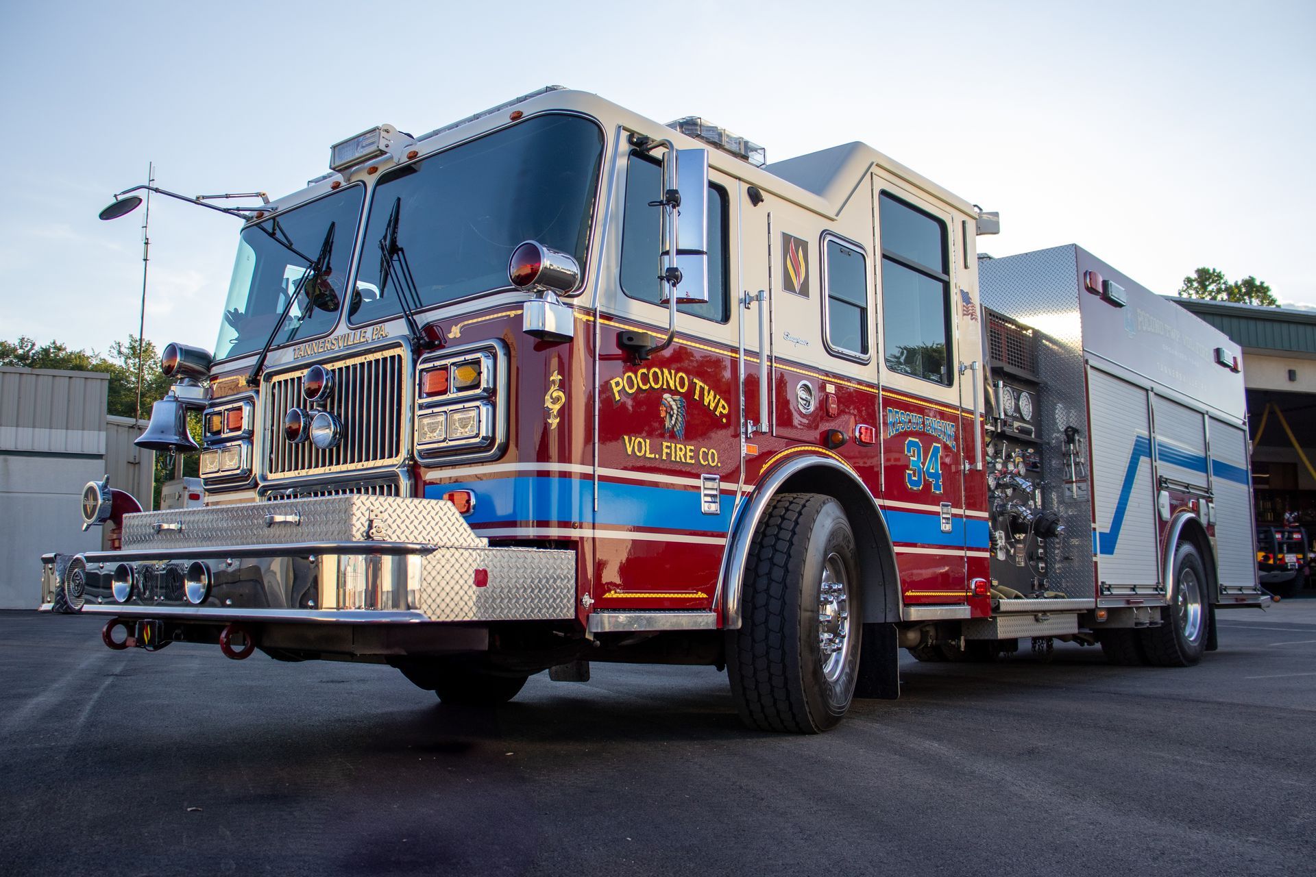 A red and white fire truck is parked in front of a building.