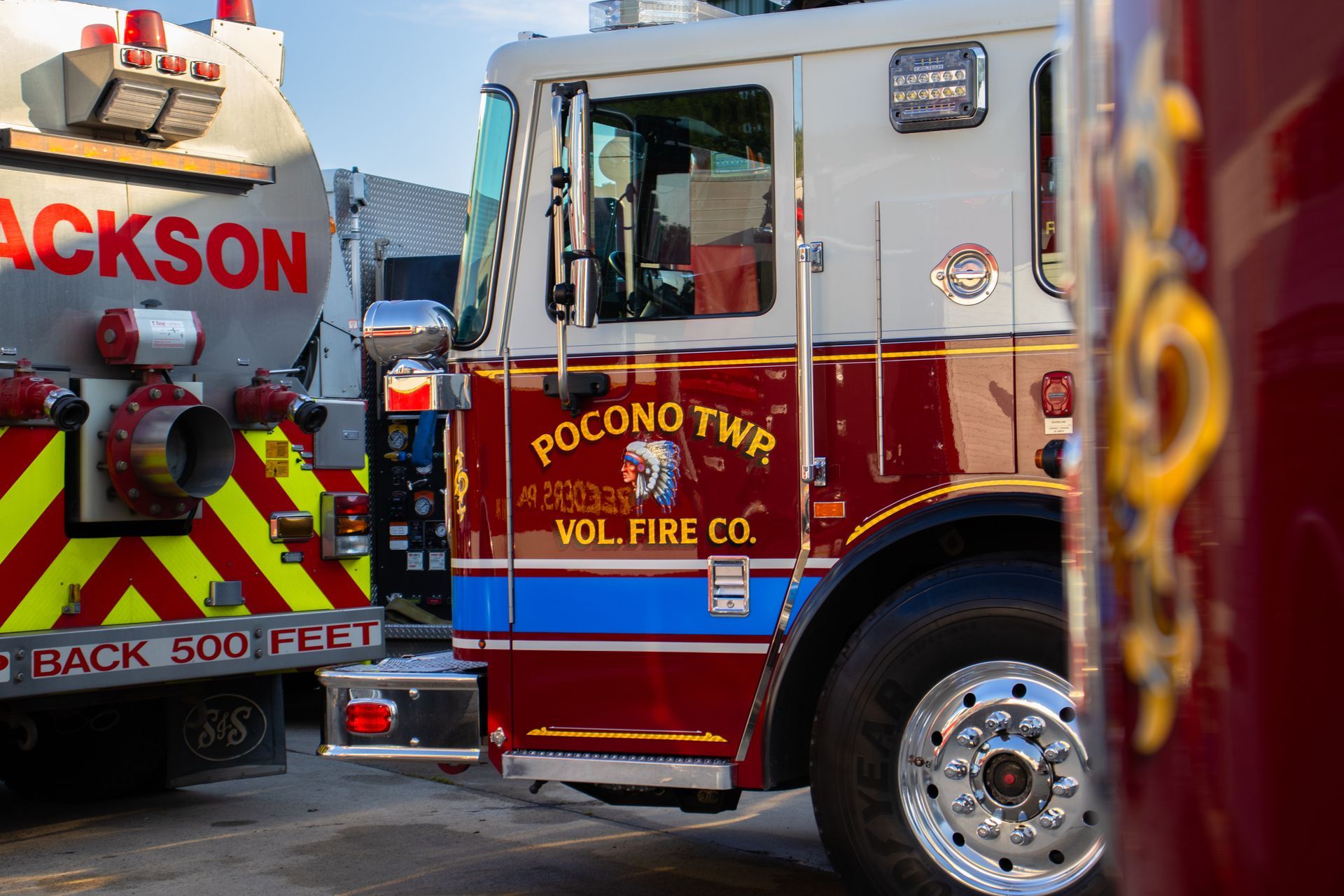 A pocono two fire truck is parked next to a jackson fire truck
