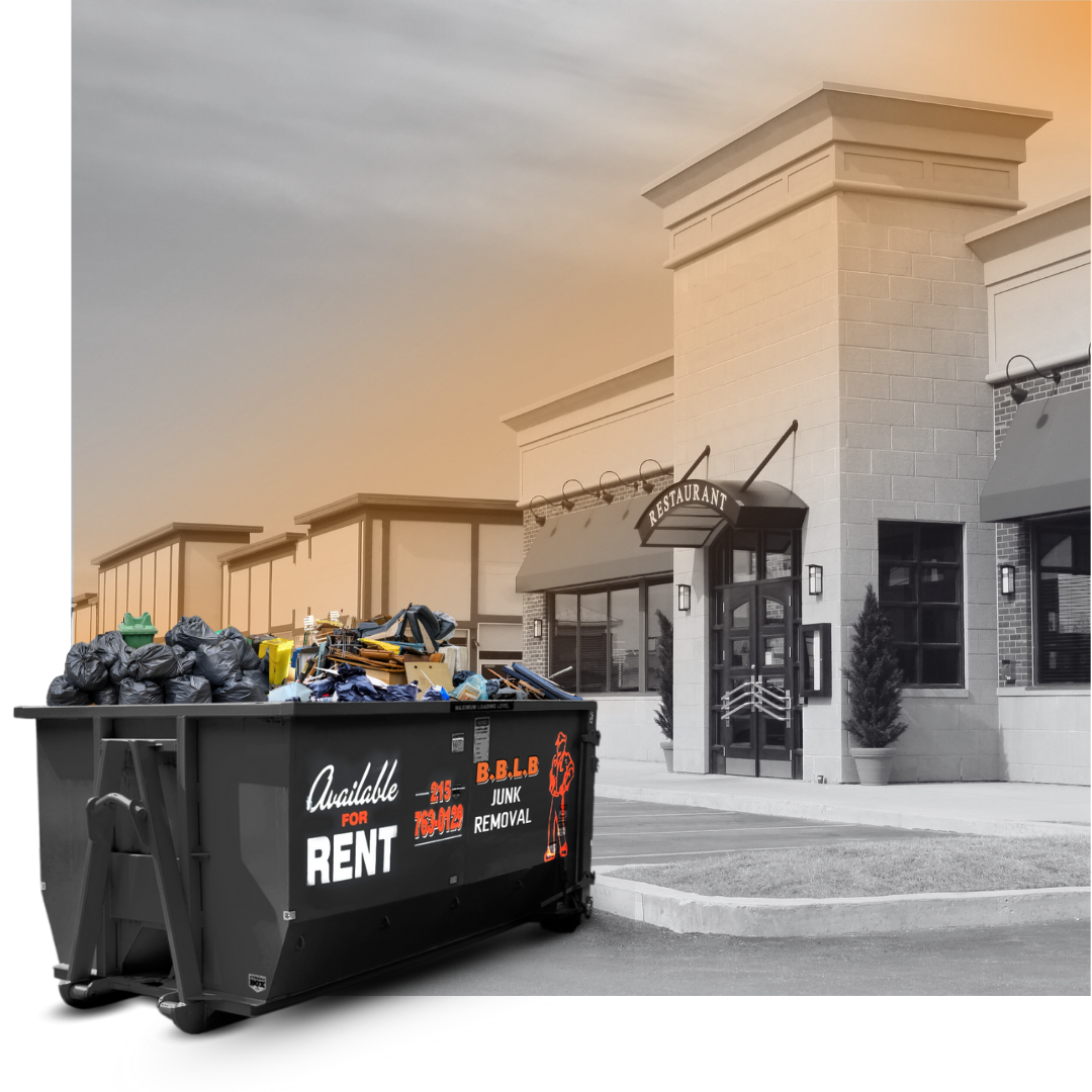 A BBLB dumpster in front a commercial building