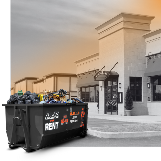 A BBLB dumpster in front a commercial building