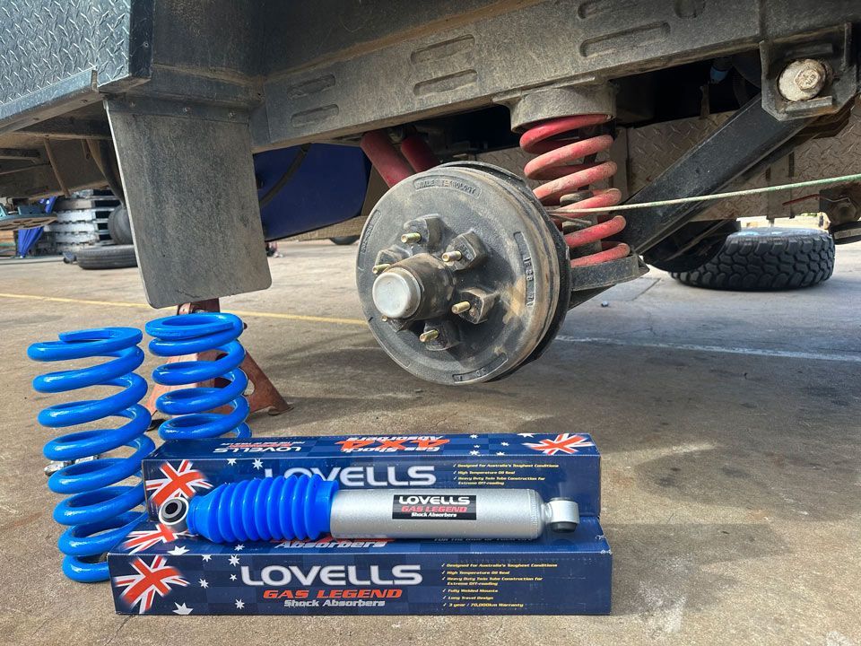 A Box Of Lovells Shock Absorbers Next To A Truck — Torque Tyres & Trailer Spares Mackay in Mackay, QLD