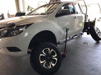 A White Truck Ready to Change Tires in Garage — Torque Tyres & Trailer Spares Mackay in Mackay, QLD