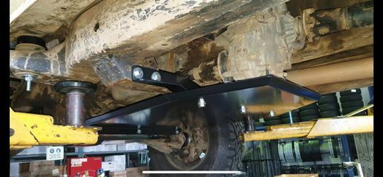 A Car Bottom View Lift In A Garage — Torque Tyres & Trailer Spares Mackay in Mackay, QLD