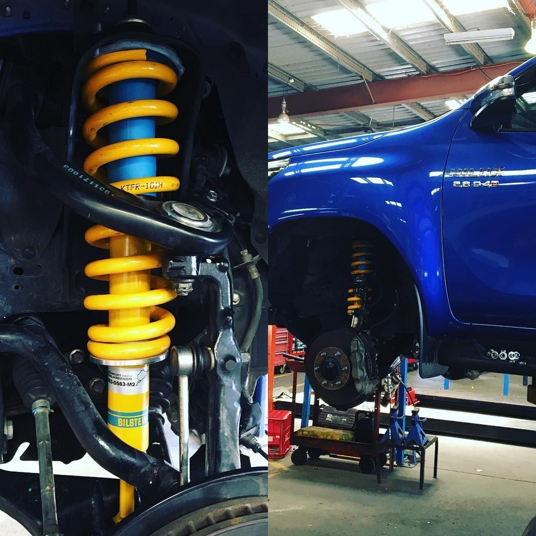 A Blue Truck Is Being Worked On In A Garage — Torque Tyres & Trailer Spares Mackay in Mackay, QLD