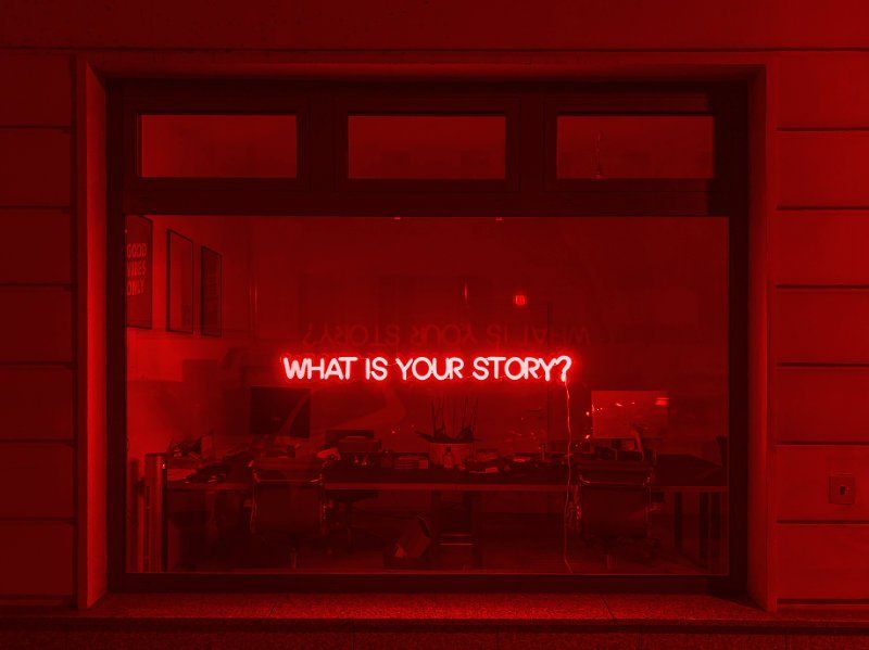 What is your story? neon sign in window