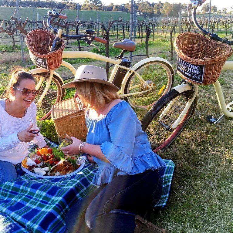 two girls enjoying a picnic lunch