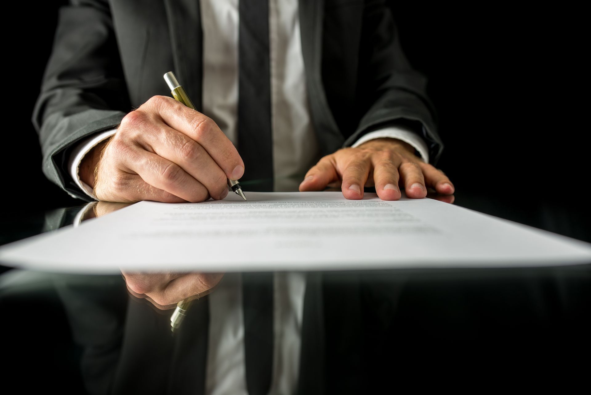 Close up of legal expert signing bail bond services agreement to secure a quick release.