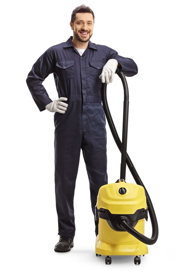man standing holding vacuum cleaner