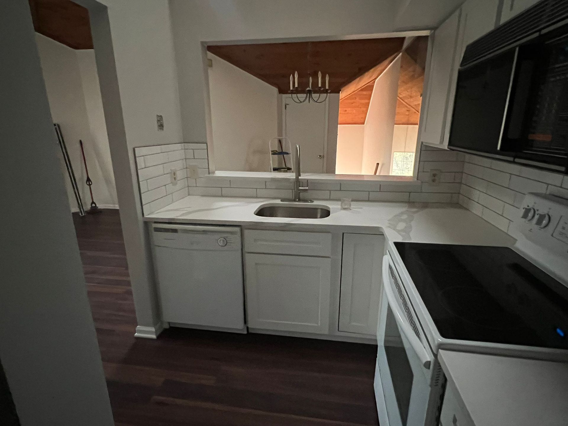 A kitchen with a sink stove and dishwasher