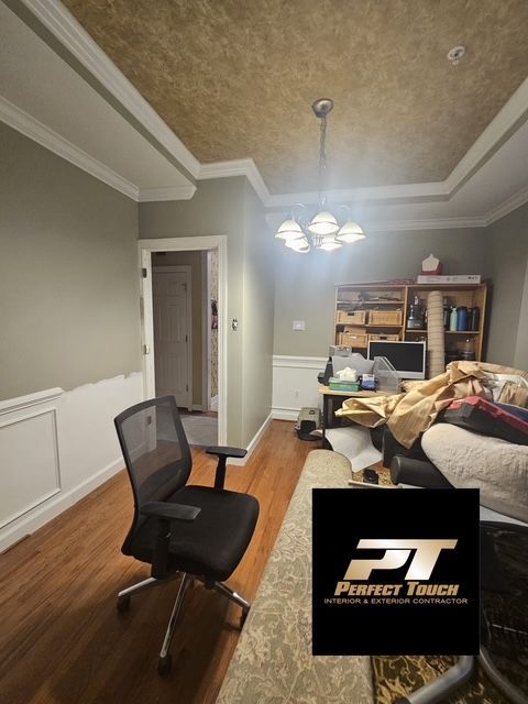 A room with a chair and a perfect touch logo