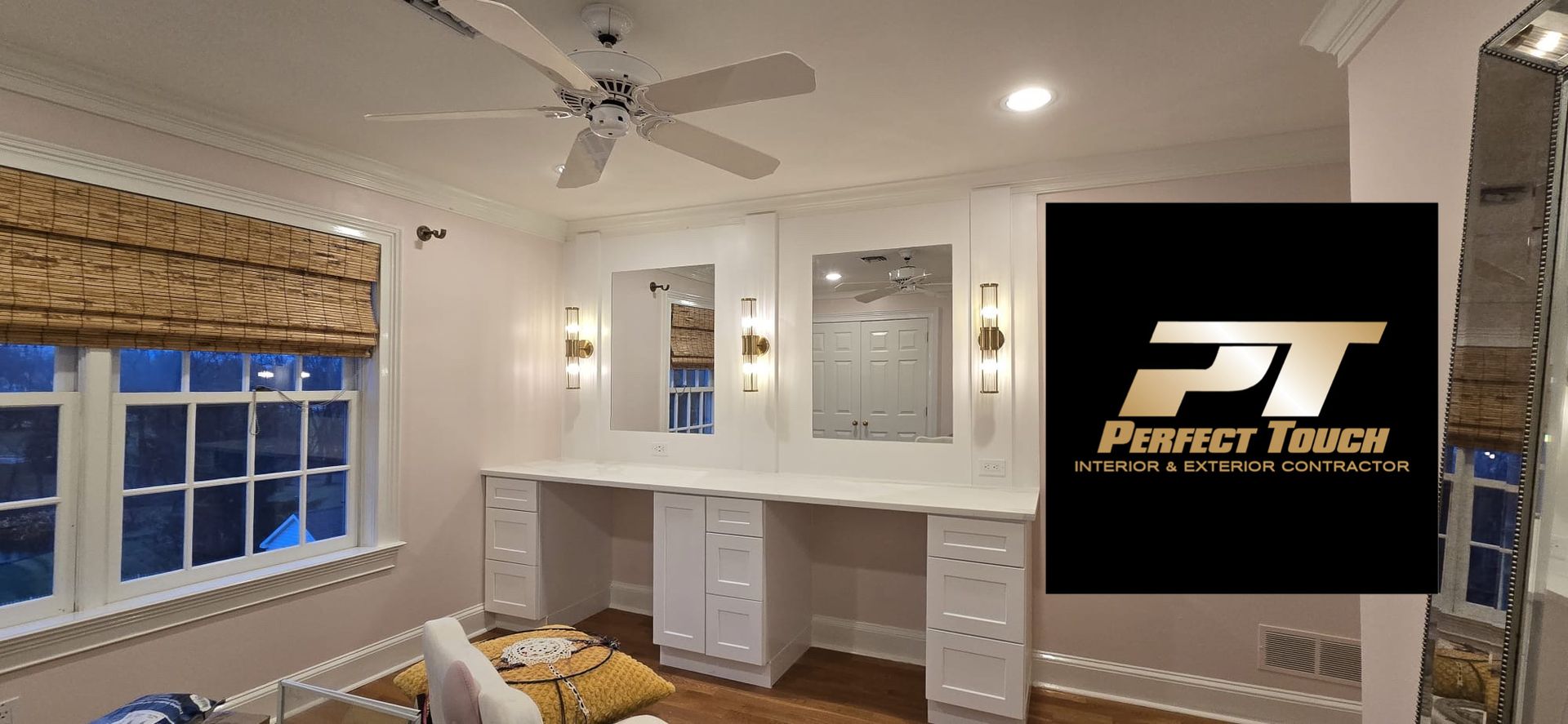 A bedroom with a ceiling fan and a logo for perfect touch.