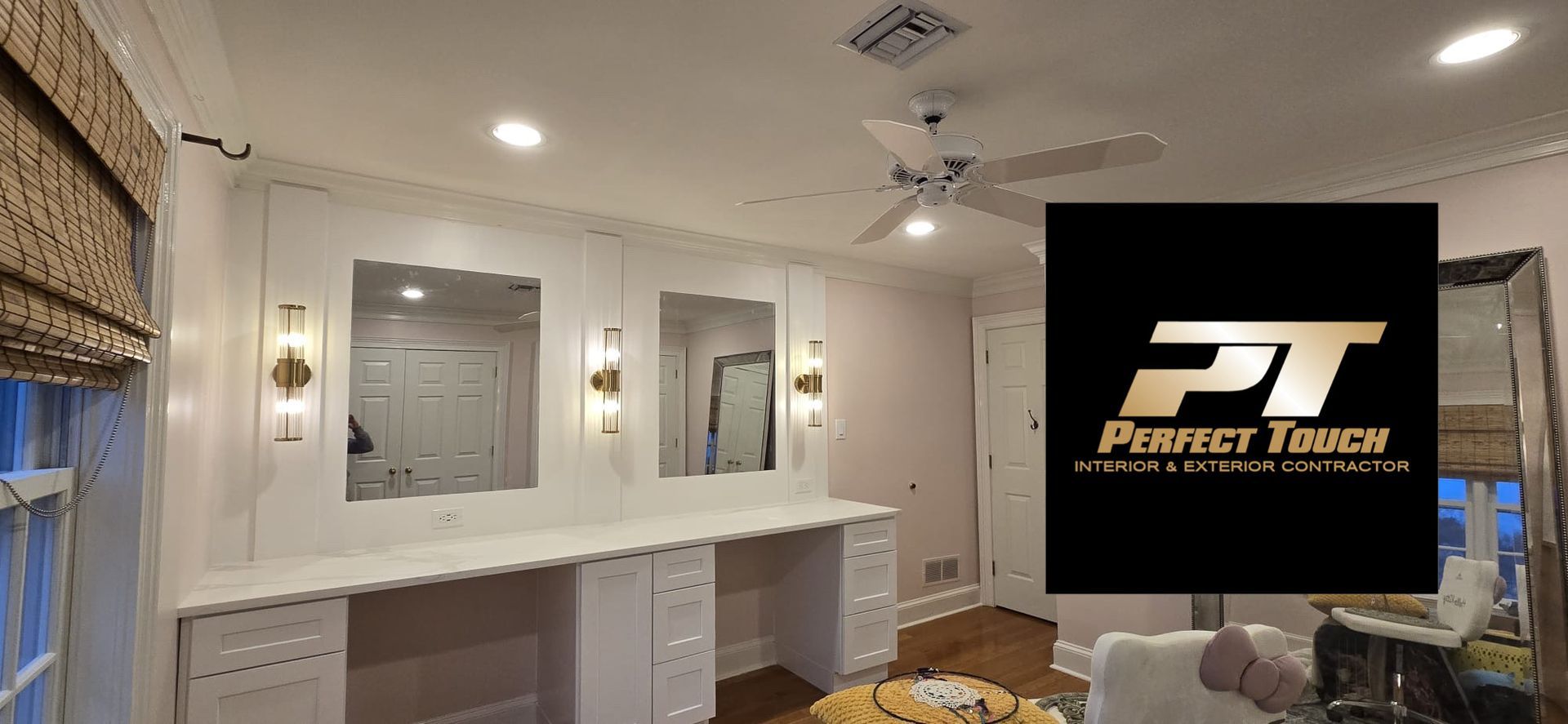 A living room with a ceiling fan and a logo for perfect touch.