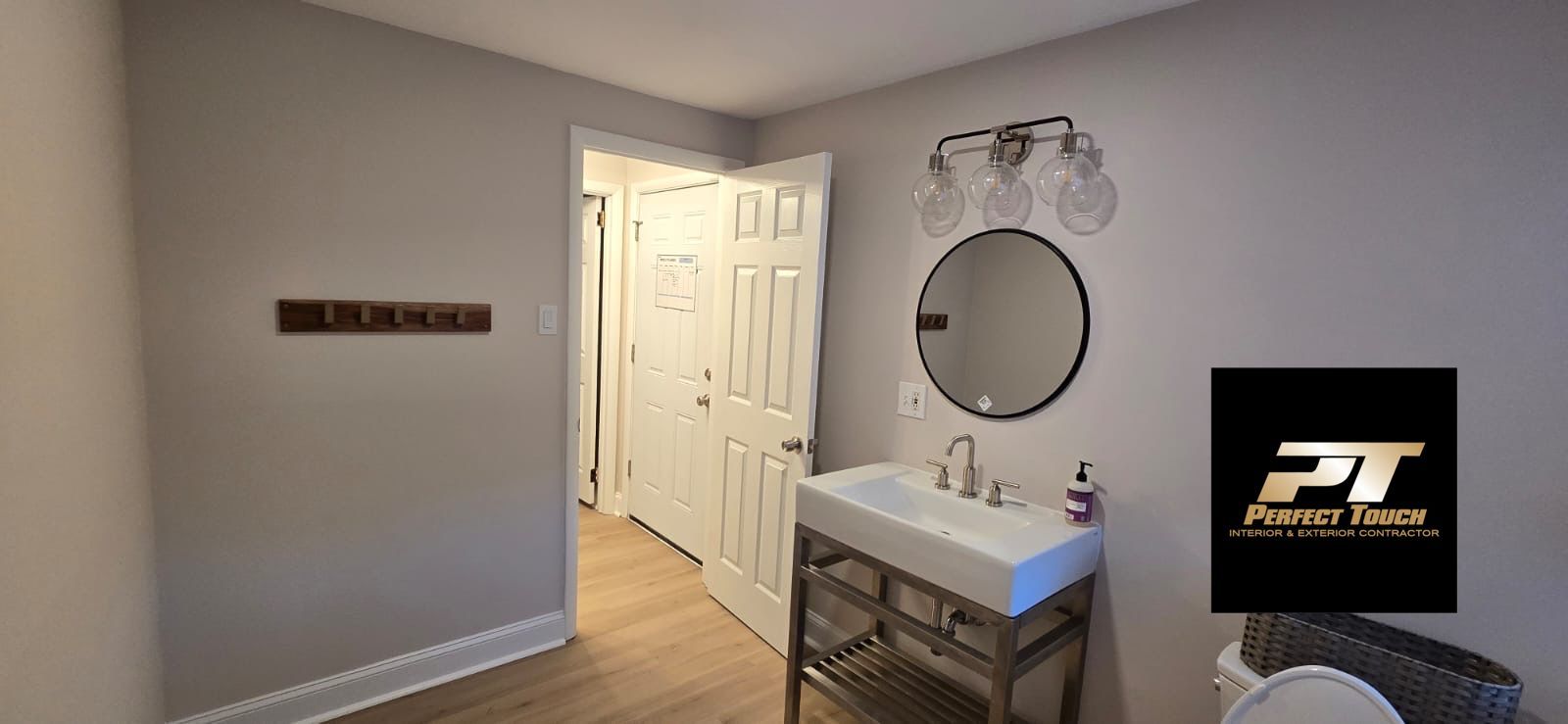 A bathroom with a sink , mirror and toilet.