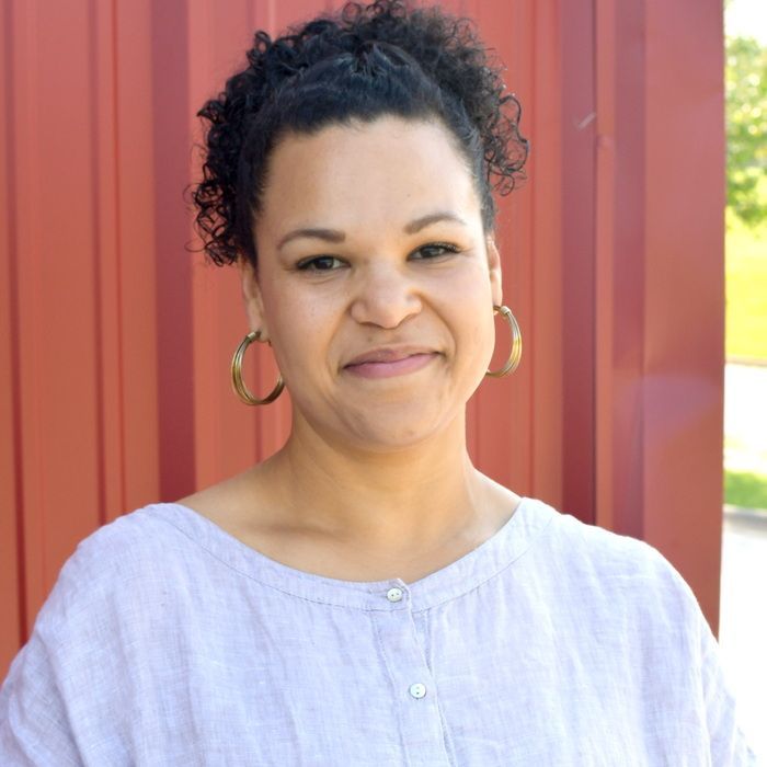 A woman wearing a blue shirt that says bliss