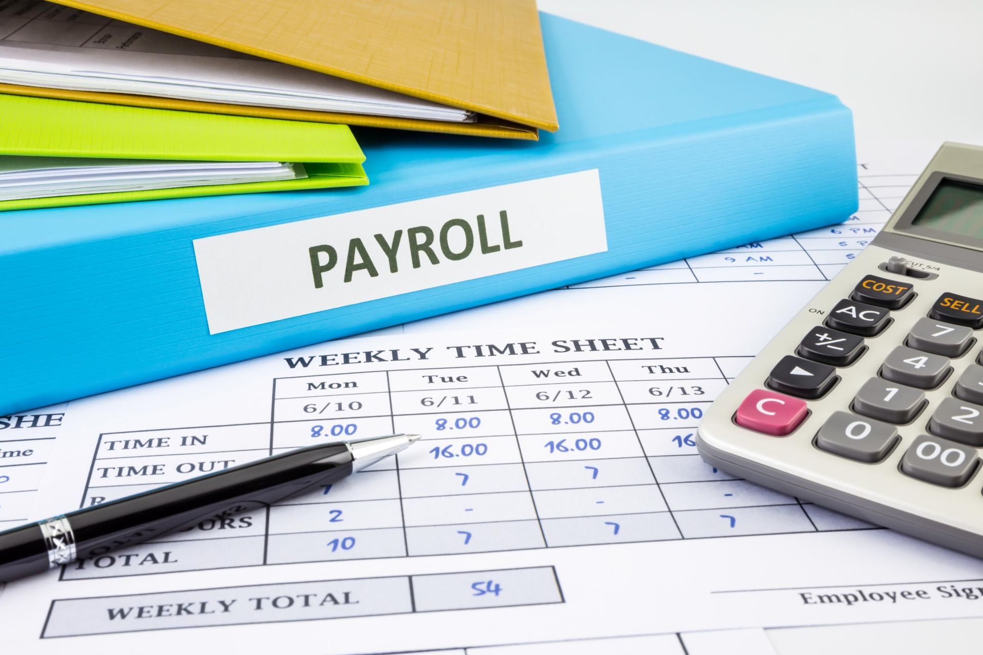 A calculator is sitting on top of a payroll sheet.