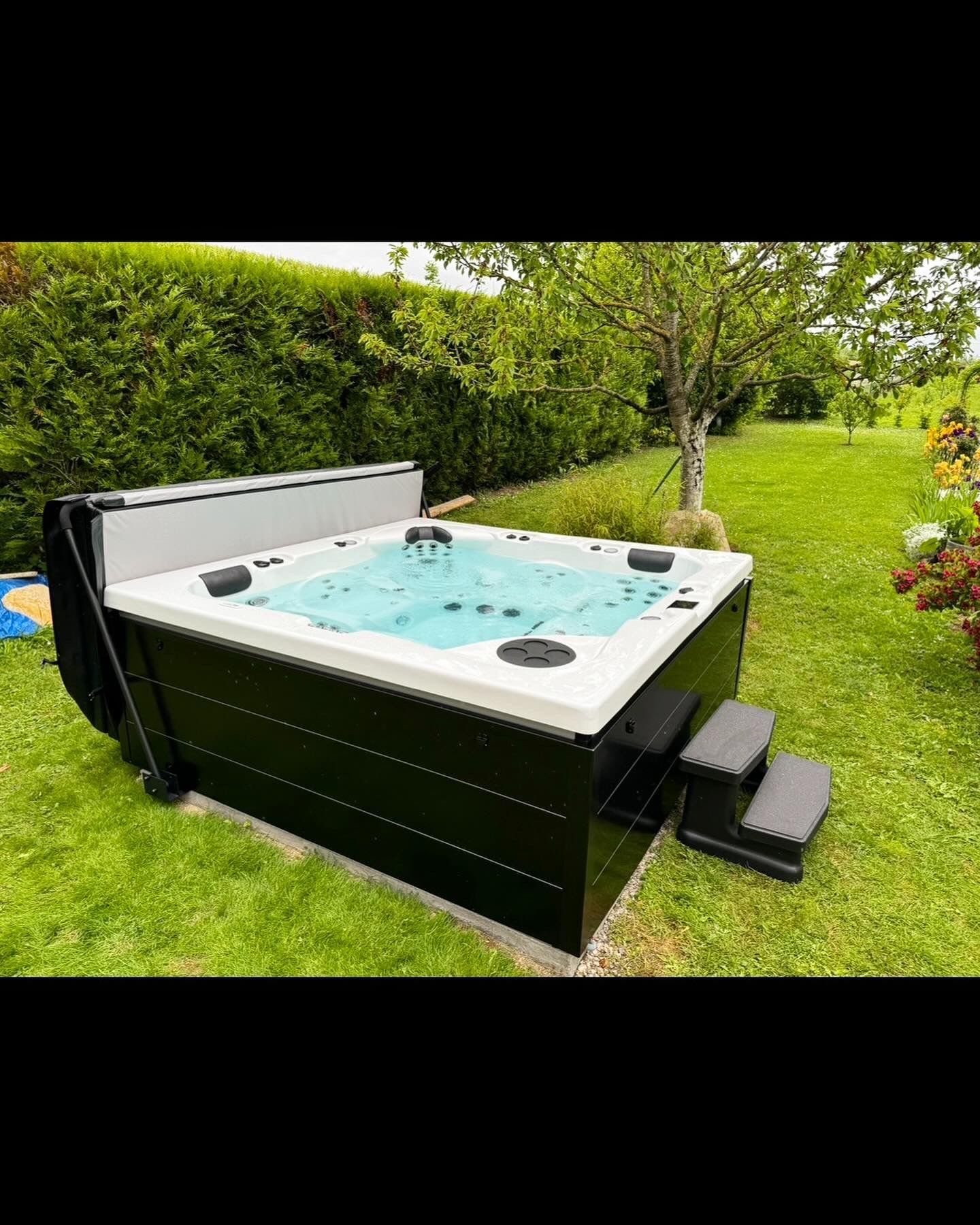 Un bain à remous est assis au milieu d'un champ vert luxuriant.