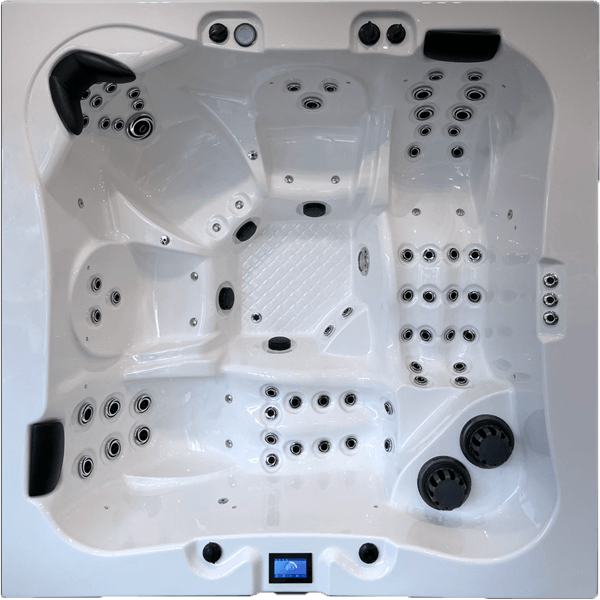 Un grand bain à remous blanc avec de nombreux jets est posé sur une surface blanche.