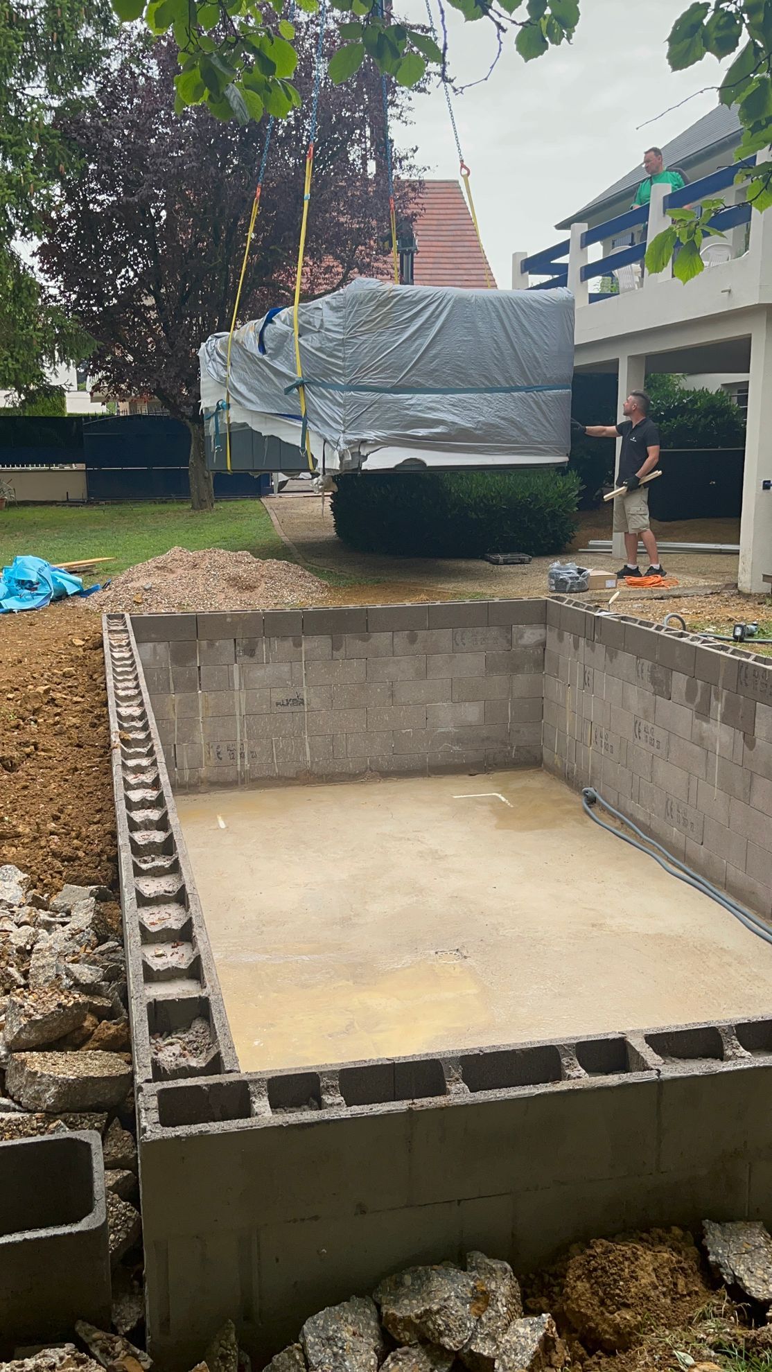 Une piscine est en cours de construction dans l'arrière-cour d'une maison.