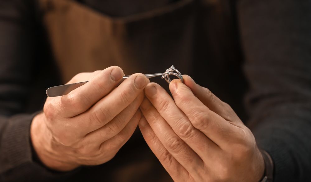 A man is holding a diamond ring in his hands - Jewellers in Dubbo, NSW