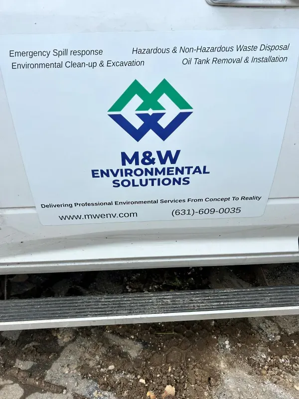 A m & w environmental solutions van is parked in the dirt