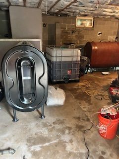 A garage filled with lots of barrels and buckets.