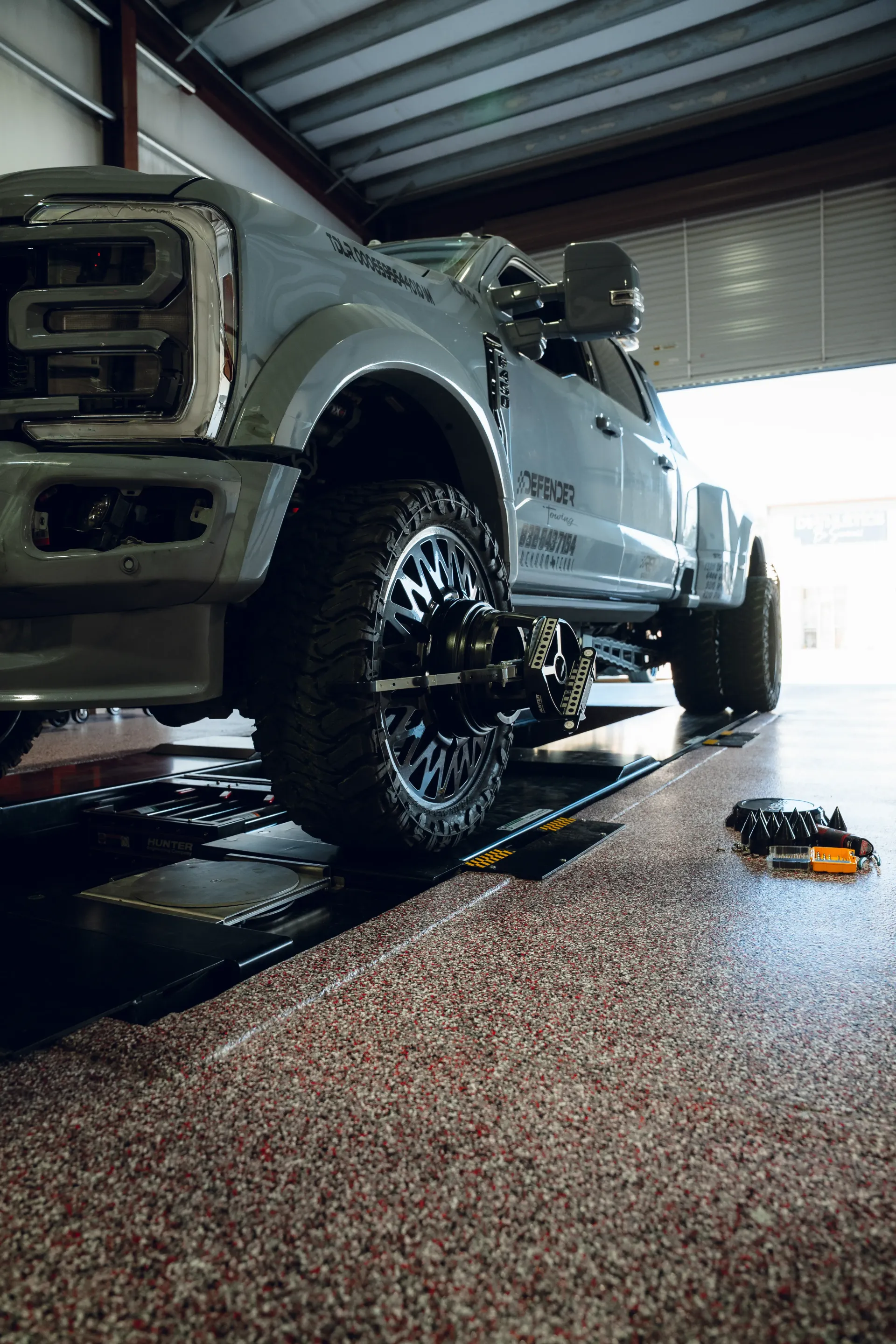 Gray pickup truck inside a garage; black wheels, shiny surface. | Advance Automotive