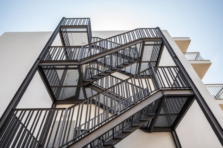 Exterior metal fire escape on a white building