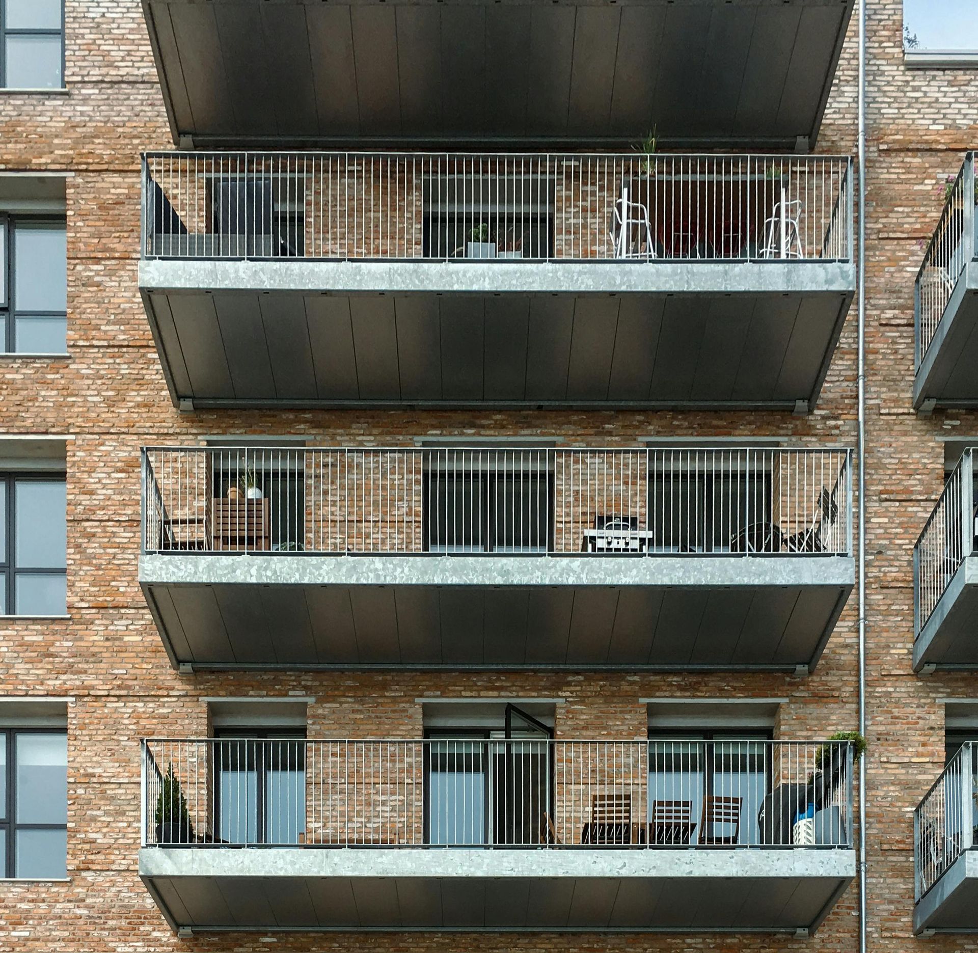Brick apartment building in Marana, AZ with stacked balconies and metal railings