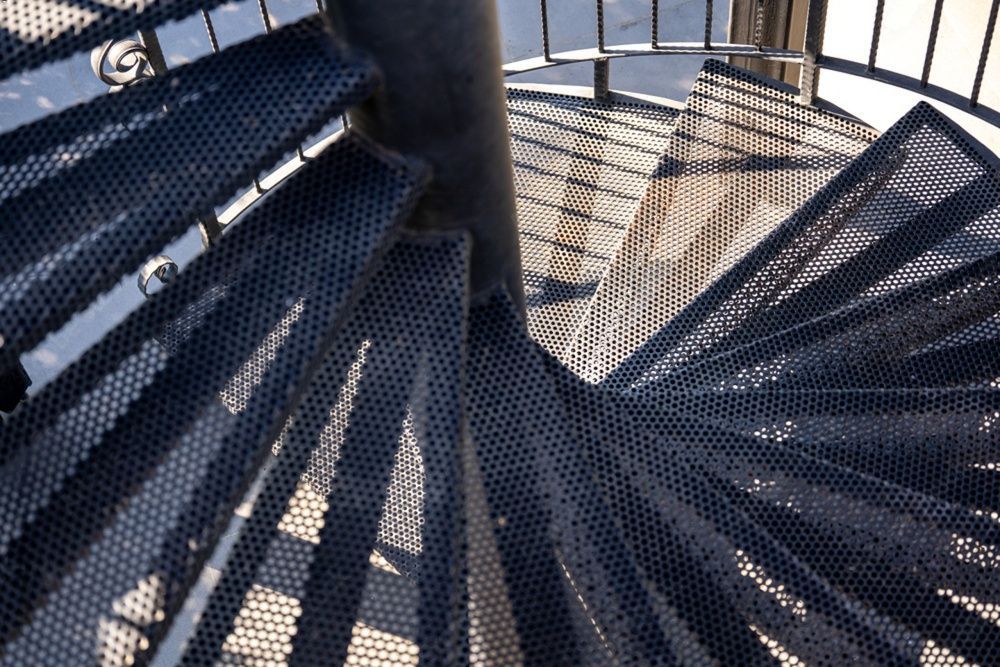 Spiral metal staircase viewed from above.