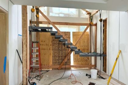 Construction site with a floating staircase installation