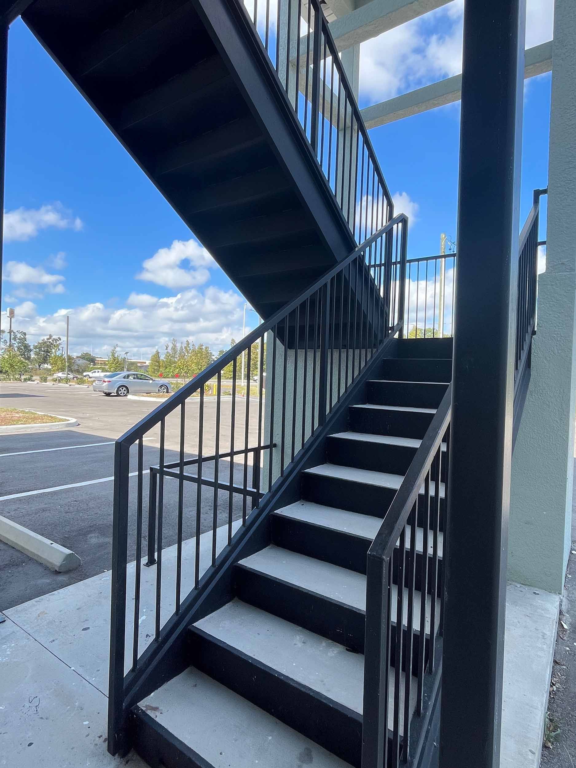 Black exterior staircase with metal railings